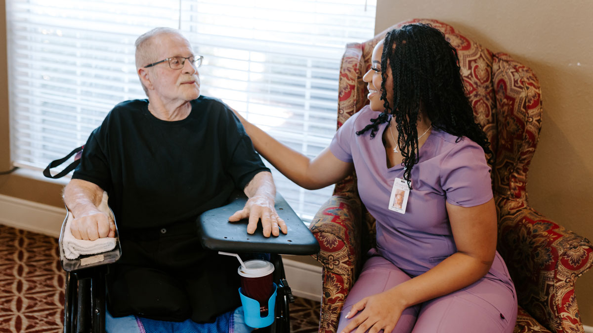 Patient Sitting with Staff Member at Brookridge Cove Rehabilitation and Care Center